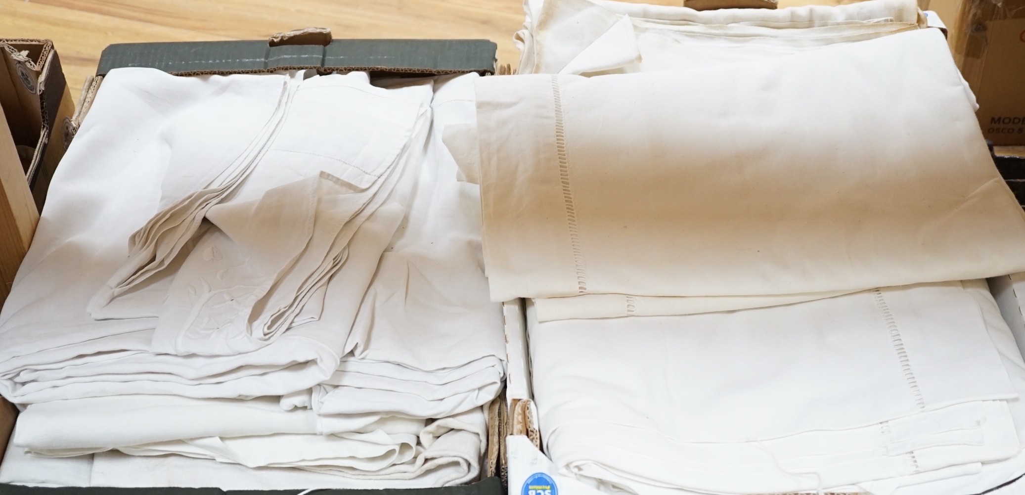 A quantity of French provincial linen sheets, some with monograms and button holed turn back